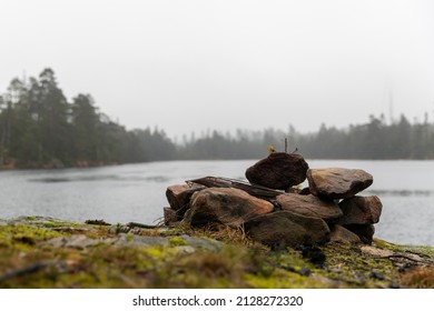 Camp Fire Site With Lake In Background. Wintertime Grey Day With No Visible People