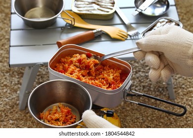 Camp Food. Making A Tomato Pasta Dish In Mess Tin And Serving It.