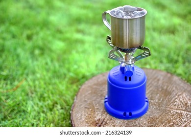 Camp Gas  Cooker And Steel Tea Mug. Background With Copy Space