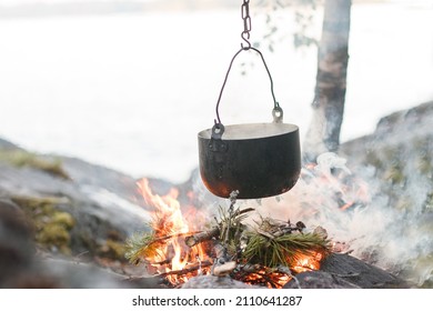 Camp kitchen, pot on the fire. On the road again. Hiking in the forest
