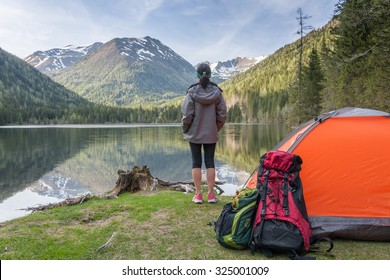 Camp in the mountains near of the lake. Bivouac on the lake in the Alps - Shutterstock ID 325001009
