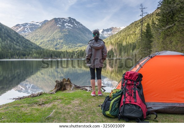Camp in the mountains near of the lake. Bivouac on\
the lake in the Alps