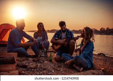 Camp on the beach.Group of young friends having picnic on the beach at night. - Powered by Shutterstock