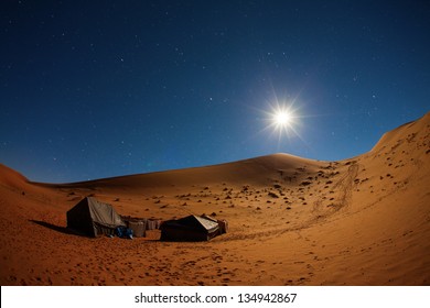 Camp In Sahara Desert In Night With Moon As Star And Moving Stars