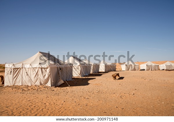 Camp of\
tents in the desert of Sahara, South\
Tunisia