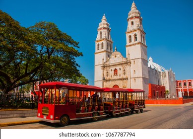 Campeche, Mexico: Independence Plaza, tourist trains and cathedral on the opposite side of the square. Old Town of San Francisco de Campeche - Powered by Shutterstock