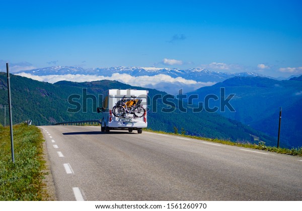 Camper car with bicycles on road trip in\
norwegian mountains. Traveling, holidays and adventure concept.\
Norway Scandinavia\
Europe.