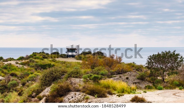 Camper car camping
on cliff above Cala Mochuela, spanish landscape along Almeria
coast. Traveling in
motorhome.