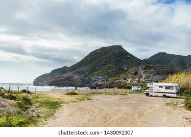 Camper Car On Spanish Beach. Cala Reona In Cabo De Palos, Murcia Region. Tourist Site. Travel In Motor Home