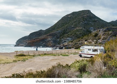 Camper Car On Spanish Beach. Cala Reona In Cabo De Palos, Murcia Region. Tourist Site. Travel In Motor Home