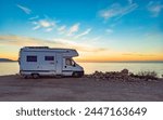 Camper car rv camping on coast sea shore at sunrise. Adventure, travel with mobile home.