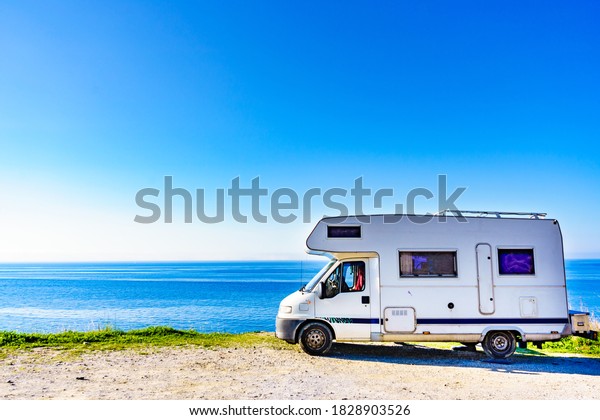 Camper rv\
caravan on mediterranean coast in Spain. Wild camping on sea shore.\
Holidays and travel in motor\
home.