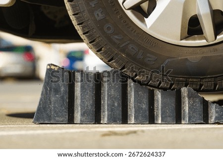 Camper using manually leveling block for level and stabilize rv. Accessories for motorhome.