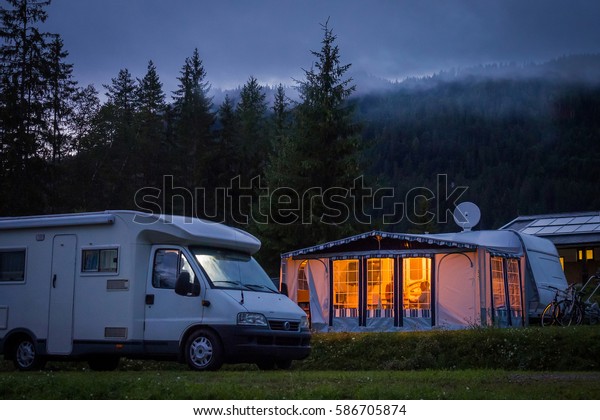 Camper van\
and awning in austrian camping at\
night