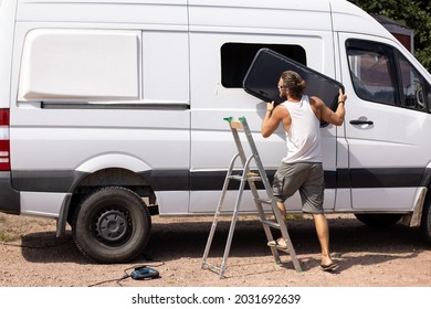 Camper Van Conversion - Man Installing A Side Window