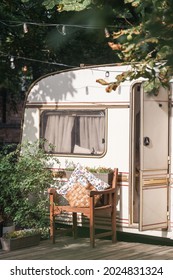 Camper Van At Nature, Trailer Exterior With Nobody. Campsite For Rv Car, Summer Camping In Park. Vertical Shot Of Cozy Caravan Facade. Outdoor Decoration Near Vehicle Open Door.