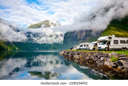 Camper van recreational vehicles (RV) parked at norwegian campsite on a fjord coast, Norway, Scandinavia