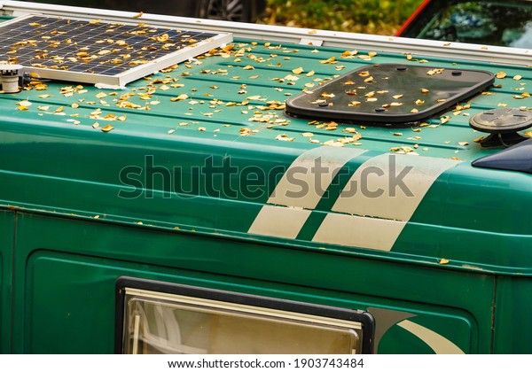Camper van
with solar panel on roof, autumn
season.