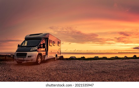 Camper Van At Sunset On Beach