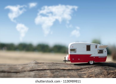 Camper van with views of the countryside and clouds in the shape of a map of the world