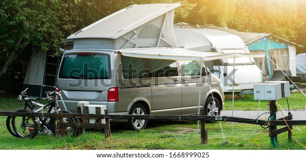 Camper vans in a camping\
park