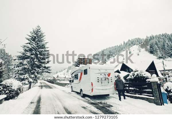 campervan caravan vehicle for van life
holiday on camper van journey camping in winter mountains near the
forest snowing on the camper outdoor nomad
lifestyle