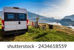 Campervan, Motorhome RV parked next to the lake or river in Bosnia and Herzegovina. Family with camper van or motor home eating breakfast on an active family vacation on a road trip to Ramsko lake.