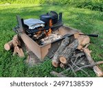 Campfire cooking over wood fire with Dutch oven