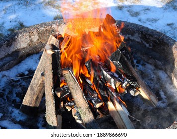 Campfire Glowing Fire Crackling in a Fire Pit Outside in the Snow While Socially Distancing
