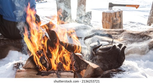 Campfire With Kettle In The Snow. Adventure In Finland.