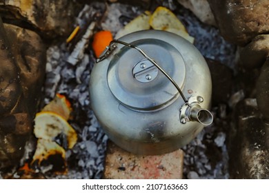 Campfire In The Middle Of Nature And Boiling Water In A Copper Kettle.