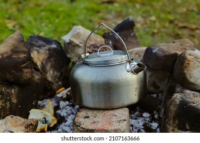 Campfire In The Middle Of Nature And Boiling Water In A Copper Kettle.