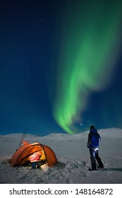 Campground on a Winter expedition with northern lights