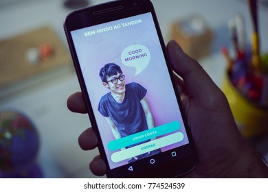 CAMPINAS CITY, BRAZIL, DECEMBER 13,  2017 - Tandem Language Learning App, One Of The Best Apps Of 2017 By Google Play Store Opened In A Smartphone, Holding Android Device In The Hand 