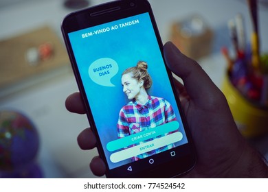 CAMPINAS CITY, BRAZIL, DECEMBER 13,  2017 - Tandem Language Learning App, One Of The Best Apps Of 2017 By Google Play Store Opened In A Smartphone, Holding Android Device In The Hand 