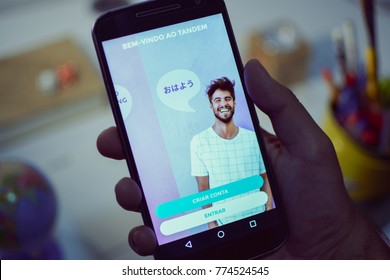 CAMPINAS CITY, BRAZIL, DECEMBER 13,  2017 - Tandem Language Learning App, One Of The Best Apps Of 2017 By Google Play Store Opened In A Smartphone, Holding Android Device In The Hand 