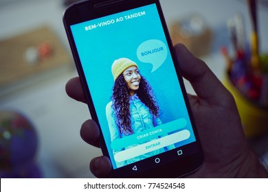CAMPINAS CITY, BRAZIL, DECEMBER 13,  2017 - Tandem Language Learning App, One Of The Best Apps Of 2017 By Google Play Store Opened In A Smartphone, Holding Android Device In The Hand 