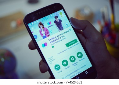 CAMPINAS CITY, BRAZIL, DECEMBER 13,  2017 - Tandem Language Learning App, One Of The Best Apps Of 2017 By Google Play Store Opened In A Smartphone, Holding Android Device In The Hand 