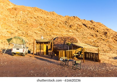 Camping in Africa with wooden shelter cabin in desert sunrise - Powered by Shutterstock