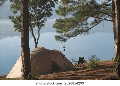 Camping alone, solo camper, Relax and enjoy in the nature. Royalty high-quality free best stock of Tent on the tranquil lake in a pine forest. Peaceful, quiet, beautiful landscape, Enjoying adventure - Powered by Shutterstock