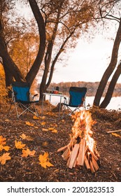 Camping Autumn Place With Bonfire And Portable Chairs No People.