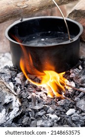 Camping. Boiling Water In A Mess Tin (pot) Over A Campfire.