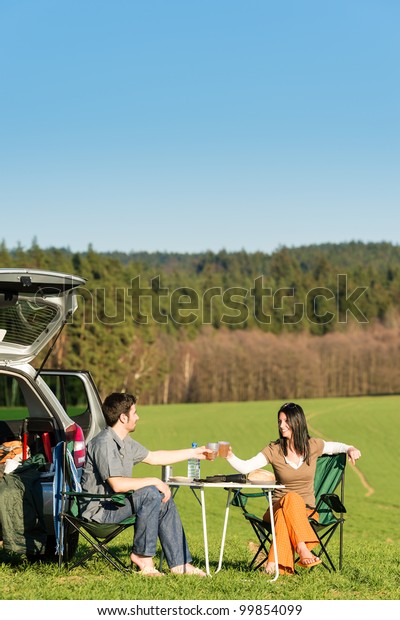 Camping car happy young couple toasting enjoy\
picnic sunny\
countryside