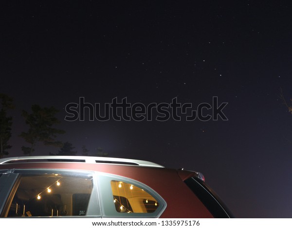 camping in the car and looking at the stars in the
night sky