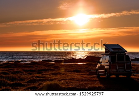 Camping car minivan on the beach at sunset. Beautiful Nature Norway natural landscape Lofoten beach.