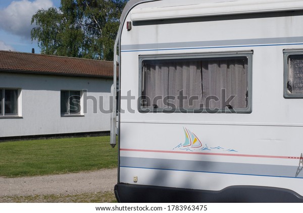Camping car(caravan) parked at a camping place,\
summer green grass