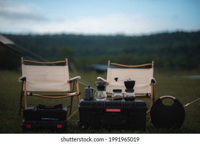 Camping Drip Coffee Maker And Chairs In The Back