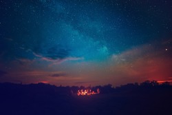 Camping Fire Under The Amazing Blue Starry Sky With A Lot Of Shining Stars And Clouds. Travel Recreational Outdoor Activity Concept.