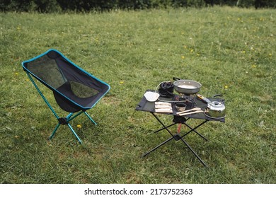 Camping Furniture, Folding Chair And Table, Outdoor Recreation, Preparation Of A Camp Kitchen, Breakfast In The Mountains, Tourist Dishes, Equipment For Trekking. High Quality Photo