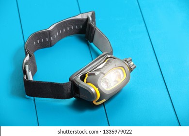 Camping Headlamp On Blue Table Background